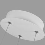 Close-up view of a modern round white pendant light mount with three metal cables attached to its underside, set against a plain gray background.