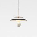 A modern pendant light with a black and gold circular shade, suspended by a thin black cord, features a white bowl-shaped diffuser beneath it, creating a striking look against the plain light gray background.
