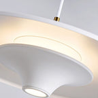 Close-up of a modern white pendant light with smooth, curved surfaces and a glowing circular center, casting a soft, warm light. The fixture hangs from a white cord with a gold accent for added elegance.