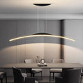 A modern dining room with a long rectangular table, surrounded by six chairs, features a sleek pendant light hanging above. Soft lighting from the pendant light creates a minimalist and elegant atmosphere. An abstract sculpture and clock sit on the table.