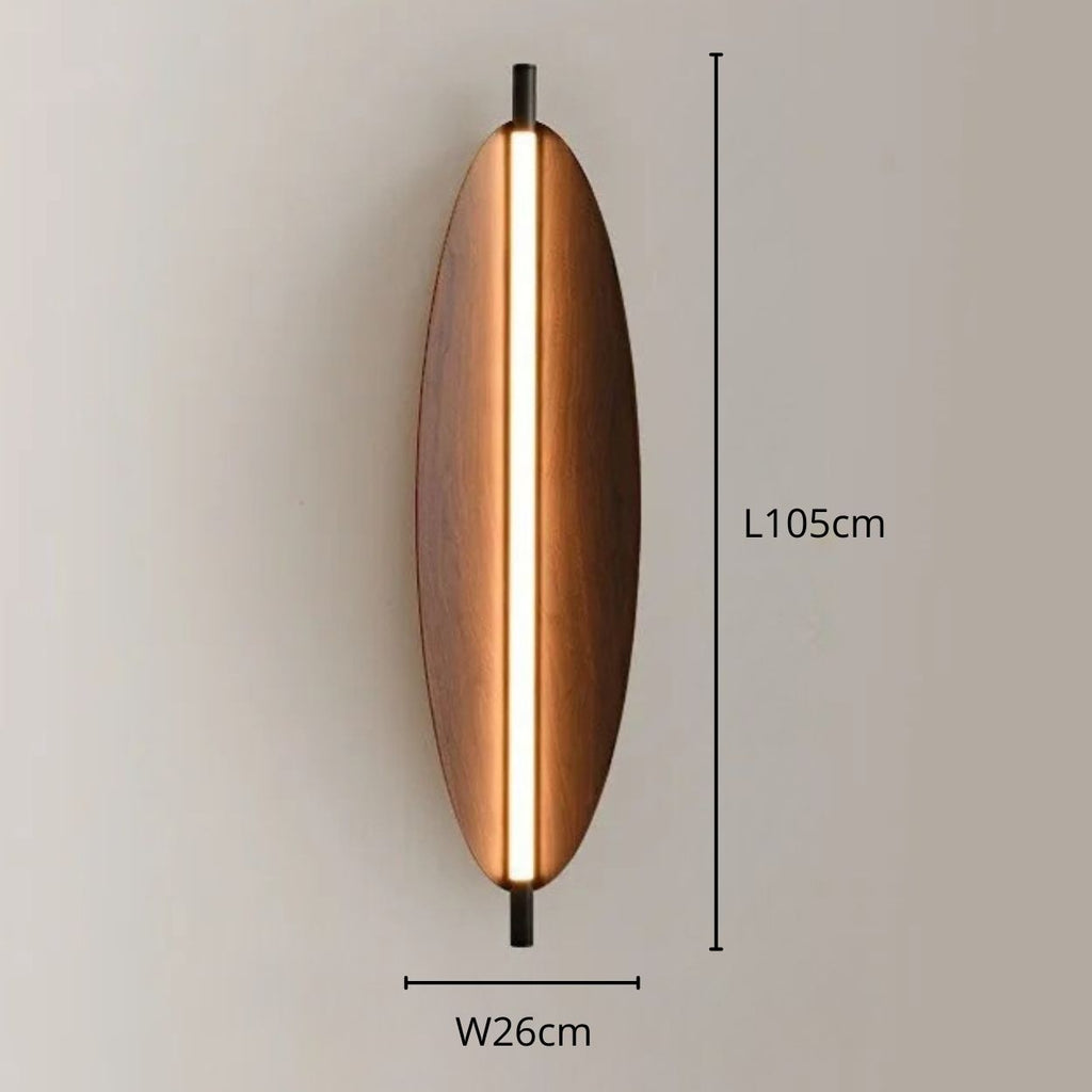 Oval-shaped wall light with a central vertical LED strip, measuring 105 cm in length and 26 cm in width, mounted on a neutral-colored wall for elegant wall lighting.