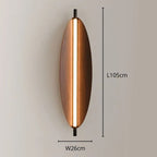 Oval-shaped wall light with a central vertical LED strip, measuring 105 cm in length and 26 cm in width, mounted on a neutral-colored wall for elegant wall lighting.