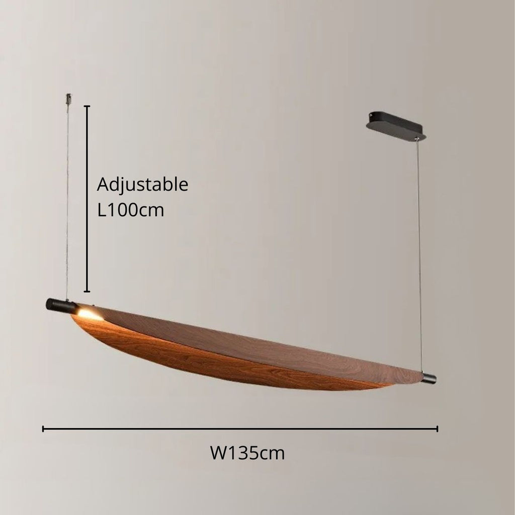 A modern wooden chandelier pendant light with a curved design, suspended by two adjustable wires (up to 100cm). The fixture, 135cm wide, features a light source at one end that beautifully illuminates the wood.