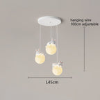 A charming pendant light fixture with three hanging bunny-shaped lights, each perched on a glowing orb. Adjustable cords extend up to 100 cm, and the fixture spans 45 cm wide. Perfect for adding whimsy to any space against a neutral background.