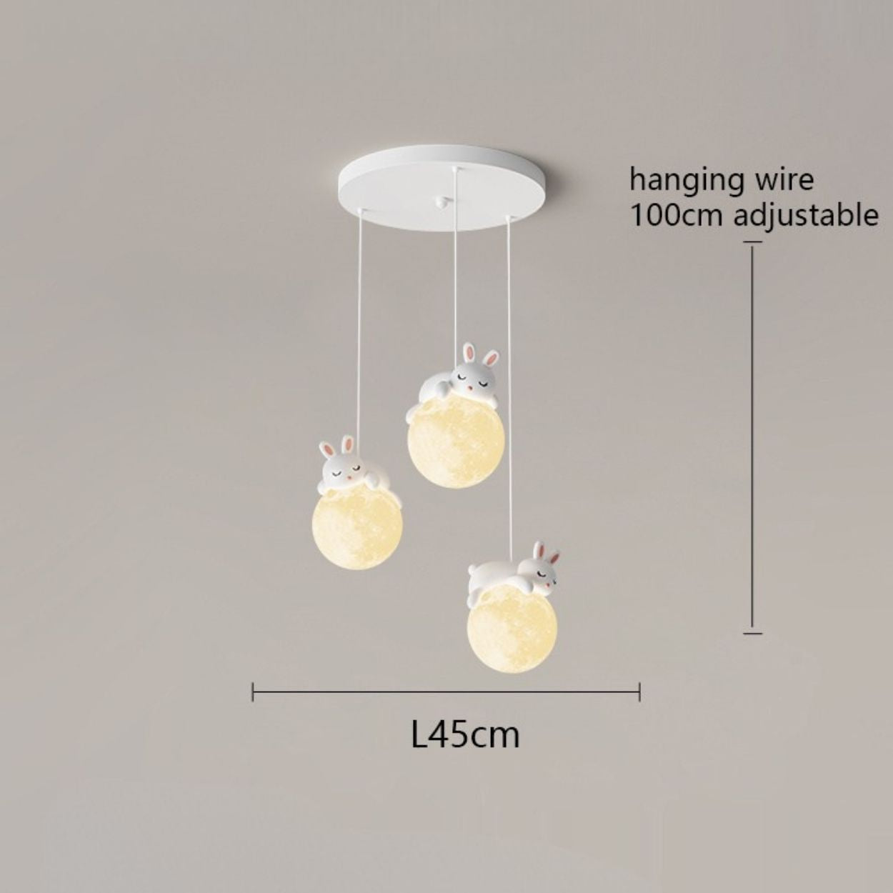 A charming pendant light fixture with three hanging bunny-shaped lights, each perched on a glowing orb. Adjustable cords extend up to 100 cm, and the fixture spans 45 cm wide. Perfect for adding whimsy to any space against a neutral background.