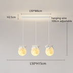 Three pendant lights shaped like glowing moons, each with a small bear figure hugging the top. These charming pendant lights hang from a rectangular ceiling mount, with dimensions and adjustable hanging wire measurements provided.