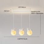 Minimalist and playful Pendant Light features three rabbit-shaped fixtures holding glowing moon-like spheres, suspended from a rectangular white base. Dimensions and adjustable wire length are labeled in centimeters.